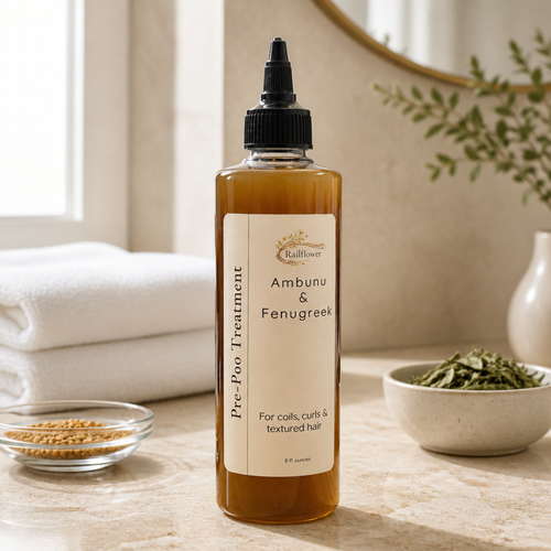 Bottle of 'Ambunu & Fenugreek' pre-poo treatment on a wooden surface with natural elements.